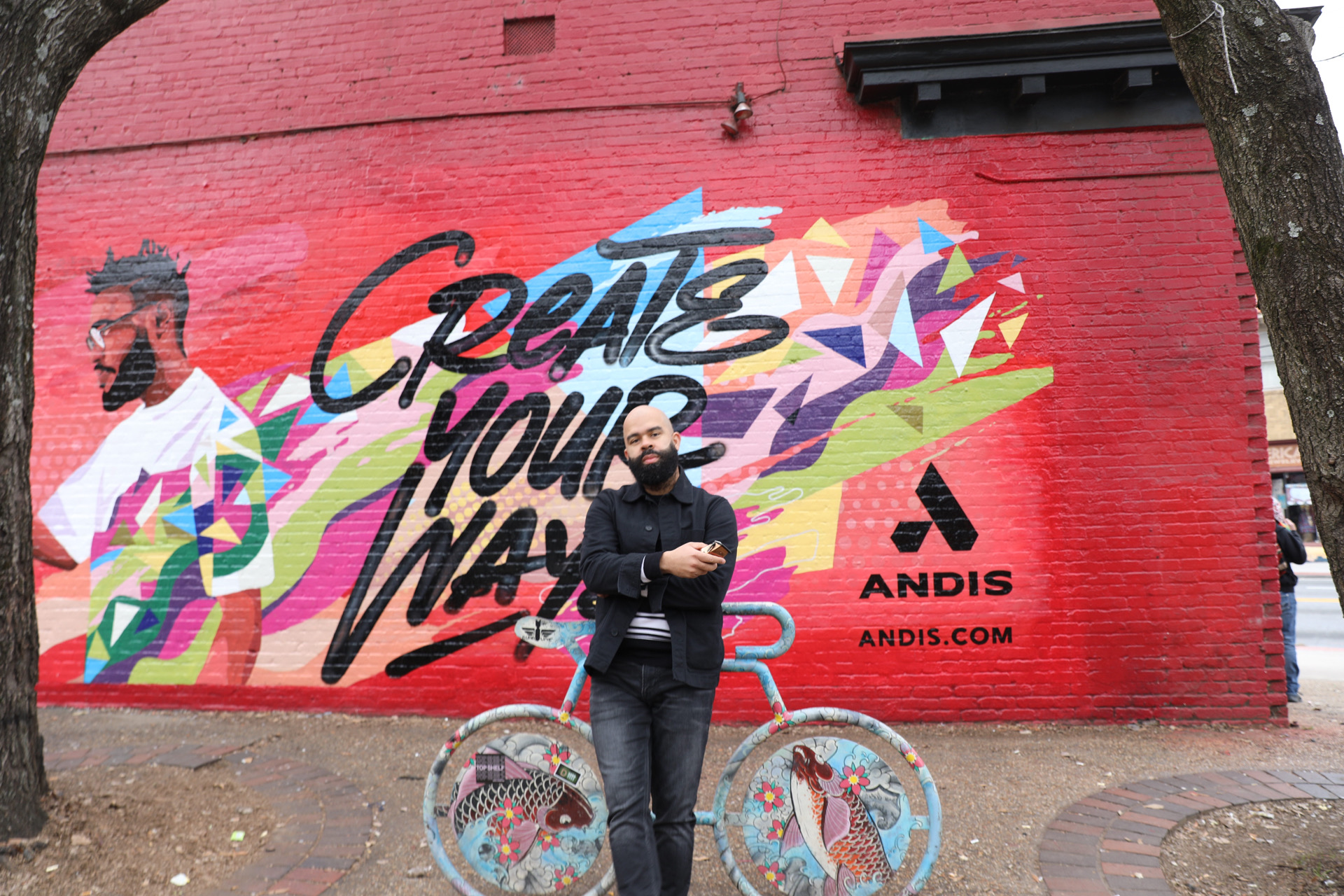 Brighter Community Atlanta Kenny Duncan standing in front of finished wall mural