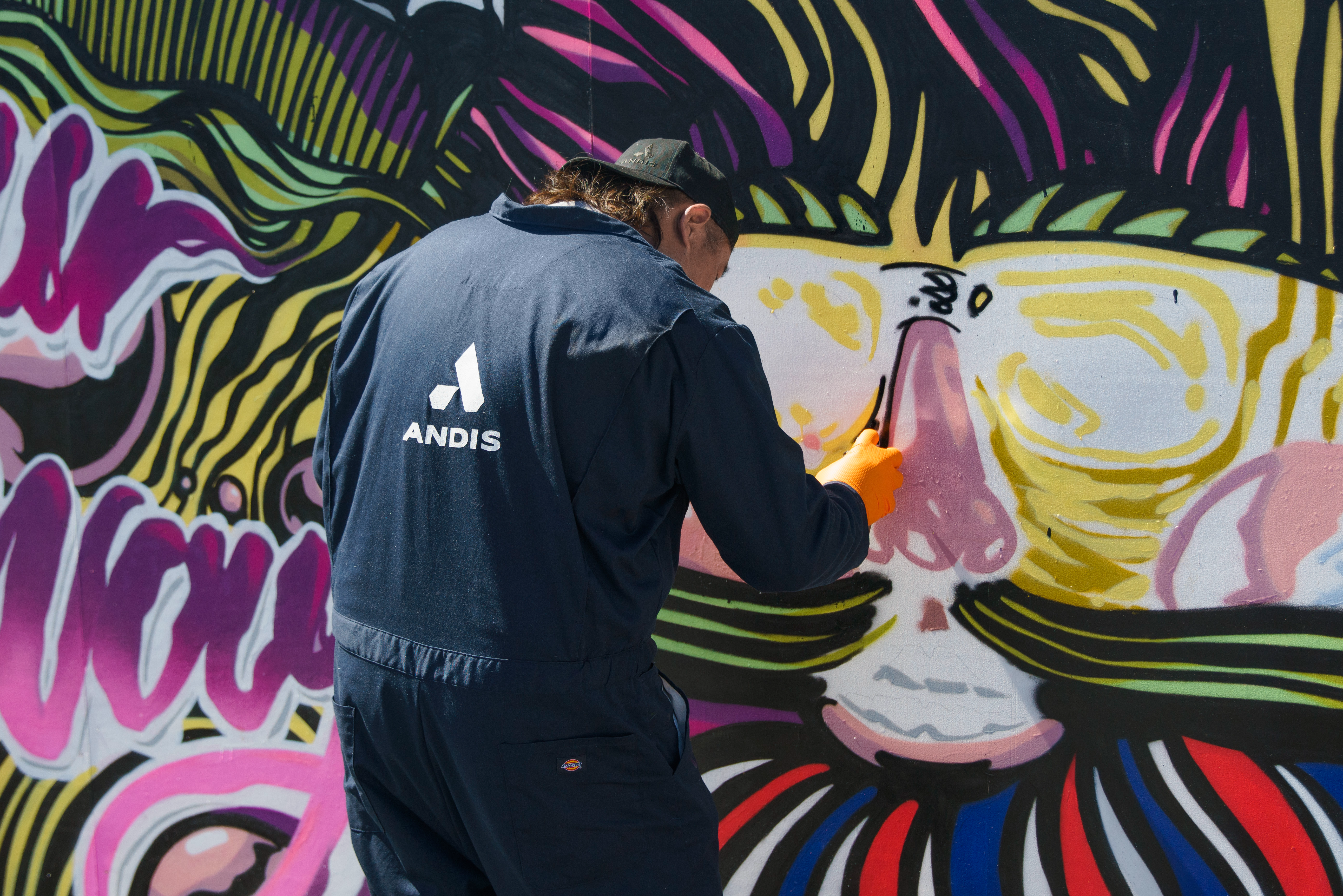 Brighter Community Venice Beach man spray painting nose on mural landscape view