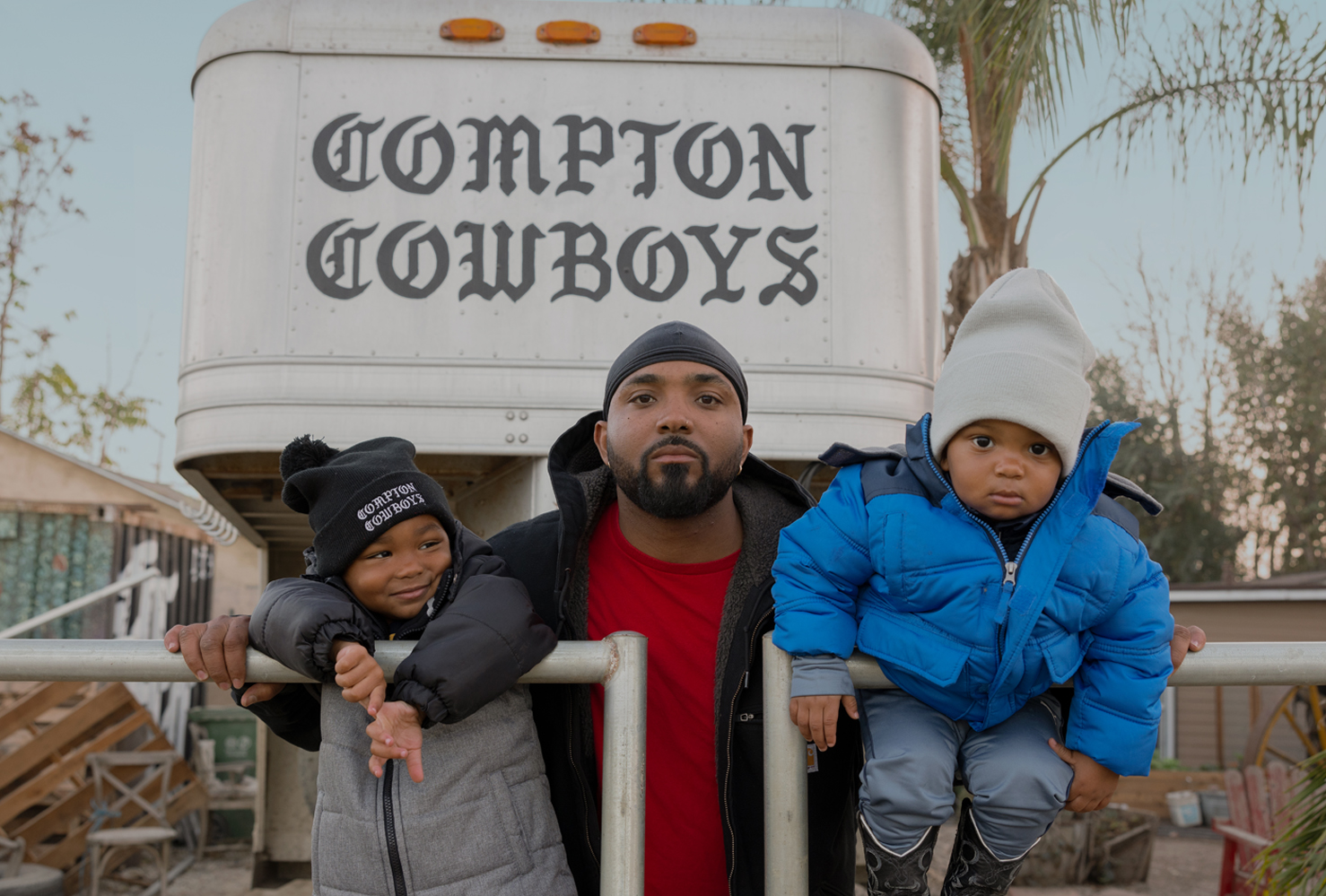 Compton Cowboys man with two small children infront of horse trailer