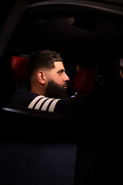 Man sitting in car looking forward.